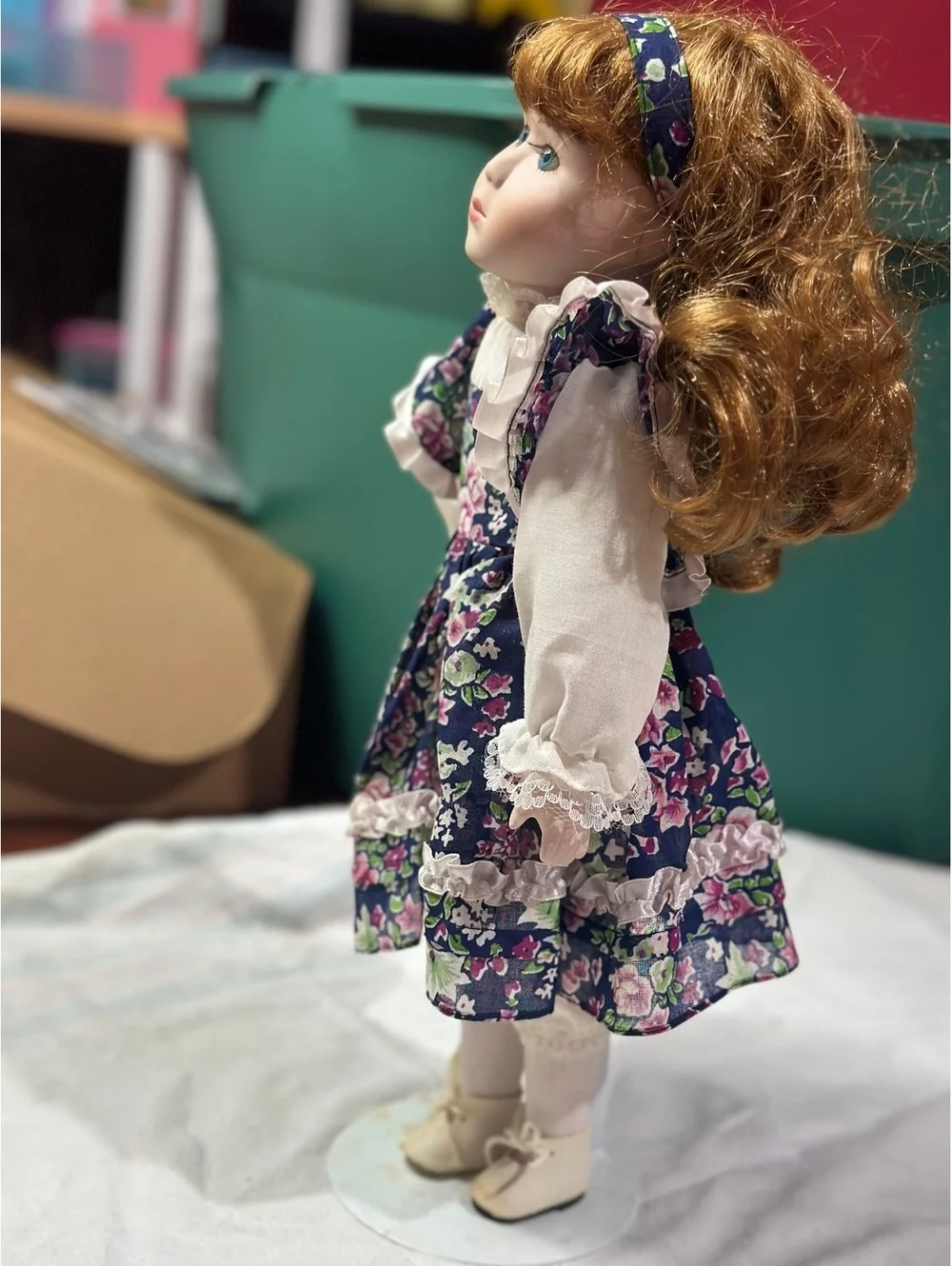 Vintage Porcelain Doll with Floral Dress and Curly Red Hair
